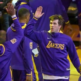 Austin Reaves high fives a player.