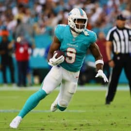 Miami Dolphins tight end Jonnu Smith runs the ball.